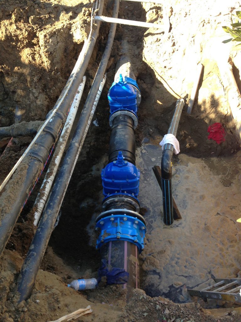 Underground water pipeline with blue gate valves during installation